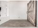 Bedroom with vinyl floors and a rustic sliding barn door at 520 S Brett St, Gilbert, AZ 85296