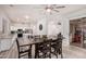 Bright dining room with a modern ceiling fan, a large table, and an open floor plan to the kitchen at 520 S Brett St, Gilbert, AZ 85296