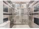 Walk-in shower boasting stylish tile work, glass door, and convenient built-in shelving at 520 S Brett St, Gilbert, AZ 85296