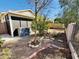 The backyard is a serene retreat with meticulous rock work, a shed, and mature trees at 9744 N 97Th Ln, Peoria, AZ 85345