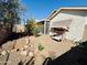 Enjoy the outdoors in this back yard with a swing, rock detail, and lush plant life at 9744 N 97Th Ln, Peoria, AZ 85345