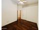 A bedroom featuring a ceiling fan, wood floors, and a closet at 9744 N 97Th Ln, Peoria, AZ 85345