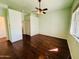 A light and airy bedroom with a ceiling fan, and an closet with white sliding doors at 9744 N 97Th Ln, Peoria, AZ 85345