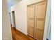 Hallway featuring dark wood floors and built in cabinets at 9744 N 97Th Ln, Peoria, AZ 85345