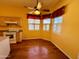 Bright kitchen eat-in area with hardwood floors, neutral cabinets, and big windows at 9744 N 97Th Ln, Peoria, AZ 85345