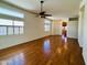 Spacious living room with hardwood floors, white walls, shutters, and ceiling fan at 9744 N 97Th Ln, Peoria, AZ 85345