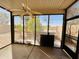 Relax in the screened-in patio with ceiling fan and views of the lush backyard at 9744 N 97Th Ln, Peoria, AZ 85345