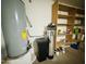 View of the home's utility closet, including water heater and water filtration system at 9744 N 97Th Ln, Peoria, AZ 85345