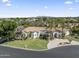 Stunning aerial view of a white home, circular driveway, lush landscaping, and mountain views in the distance at 2222 N Val Vista Dr # 3, Mesa, AZ 85213