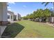 Large backyard features a well-manicured lawn, mature trees, and a patio area perfect for outdoor living at 2222 N Val Vista Dr # 3, Mesa, AZ 85213