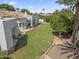 Aerial view of the backyard showing the home's covered patio, expansive lawn, and mature trees at 2222 N Val Vista Dr # 3, Mesa, AZ 85213