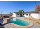 Inviting kidney-shaped pool in the backyard with a spacious patio area at 3155 W Augusta Ave, Phoenix, AZ 85051