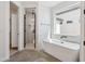 Bright bathroom with free standing tub, glass shower, and modern fixtures and finishes at 13653 E Aloe Vera Dr, Scottsdale, AZ 85262
