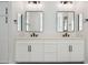 Bright bathroom features a double sink vanity, white cabinets, modern fixtures and finishes at 13653 E Aloe Vera Dr, Scottsdale, AZ 85262