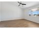 Bright bedroom features wood-look floors, modern ceiling fan, and large window with scenic views at 13653 E Aloe Vera Dr, Scottsdale, AZ 85262