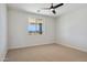 Inviting bedroom with a ceiling fan and large window showcasing mountain views at 13653 E Aloe Vera Dr, Scottsdale, AZ 85262