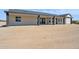 Home exterior with covered patio, dark accents, and a spacious backyard at 13653 E Aloe Vera Dr, Scottsdale, AZ 85262