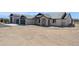Beautiful house featuring a 5-car garage, stone details, manicured landscaping, and a well-maintained lawn at 13653 E Aloe Vera Dr, Scottsdale, AZ 85262