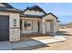 Inviting home showcasing stone details, modern windows, and stylish lighting fixtures at 13653 E Aloe Vera Dr, Scottsdale, AZ 85262