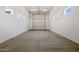 Garage with white walls, concrete flooring, and a modern roll-up door at 13653 E Aloe Vera Dr, Scottsdale, AZ 85262