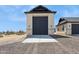 Detached garage featuring modern exterior with stone accents and gray garage door at 13653 E Aloe Vera Dr, Scottsdale, AZ 85262