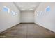 Spacious garage featuring natural light from multiple windows and a durable concrete floor at 13653 E Aloe Vera Dr, Scottsdale, AZ 85262