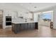 Modern kitchen with a dark island, quartz countertop, and mountain views at 13653 E Aloe Vera Dr, Scottsdale, AZ 85262