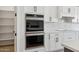 Modern kitchen featuring stainless double oven, white cabinets, and subway tile at 13653 E Aloe Vera Dr, Scottsdale, AZ 85262