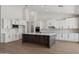 Spacious kitchen features a dark island, white cabinetry, and stainless appliances at 13653 E Aloe Vera Dr, Scottsdale, AZ 85262