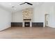 Living room featuring a striking stone fireplace, built-in cabinets, and stylish wood-look tile floors at 13653 E Aloe Vera Dr, Scottsdale, AZ 85262