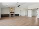 Cozy living room with stone fireplace, built-in cabinets, wood-look tile flooring, and barn door access at 13653 E Aloe Vera Dr, Scottsdale, AZ 85262