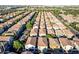 An aerial view shows rows of townhomes and vibrant greenery in a well-planned community at 955 S Henry Ln, Gilbert, AZ 85296