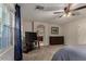 This bedroom is spacious with a ceiling fan, closet, and a window looking out onto the backyard at 955 S Henry Ln, Gilbert, AZ 85296