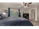 The main bedroom features a large bed, ceiling fan, and sliding glass door to the backyard at 955 S Henry Ln, Gilbert, AZ 85296