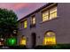 Charming two-story home with landscaped front yard and a tiled roof, illuminated by warm interior lighting at 955 S Henry Ln, Gilbert, AZ 85296