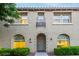 Charming two-story home with landscaped front yard and a tiled roof, with a sidewalk to front door at 955 S Henry Ln, Gilbert, AZ 85296