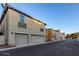 Charming home with a two-car garage, decorative lights, and planter boxes under the windows at 955 S Henry Ln, Gilbert, AZ 85296