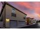 Charming home with a two-car garage, decorative lights, and planter boxes under the windows at 955 S Henry Ln, Gilbert, AZ 85296