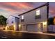 Inviting townhome featuring a two-car garage and charming planter boxes beneath the windows at 955 S Henry Ln, Gilbert, AZ 85296