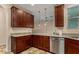This spacious kitchen features granite countertops, stainless steel appliances, and beautiful wood cabinets at 955 S Henry Ln, Gilbert, AZ 85296