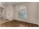 Bright living room featuring a window with a half-moon transom, and modern flooring at 955 S Henry Ln, Gilbert, AZ 85296