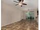 Spacious living room featuring neutral carpet, a ceiling fan and sliding glass doors for natural light at 955 S Henry Ln, Gilbert, AZ 85296