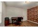 Home office with hardwood floors features a dark desk, office chair and accent wall at 955 S Henry Ln, Gilbert, AZ 85296