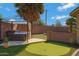 Backyard with a hot tub, putting green, and seating area offers the perfect entertainment space at 1859 N Morris --, Mesa, AZ 85201
