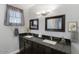 Bathroom features a dual sink vanity, attractive light fixture, and framed mirrors at 1859 N Morris --, Mesa, AZ 85201