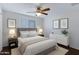 This bedroom features a ceiling fan, queen-sized bed, and a dresser at 1859 N Morris --, Mesa, AZ 85201
