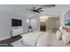 This main bedroom features a large bed, dresser with TV, and a peak into the bathroom at 1859 N Morris --, Mesa, AZ 85201
