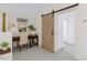 Well-lit office space with desk, laundry sign, sliding barn door, and neutral decor at 1859 N Morris --, Mesa, AZ 85201