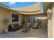 Cozy outdoor patio area with modern seating and shade cover provides a relaxing retreat at 1859 N Morris --, Mesa, AZ 85201