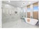 Bright bathroom featuring a glass enclosed shower, soaking tub, and marble accents for a luxurious feel at 10646 E Butherus Dr, Scottsdale, AZ 85255